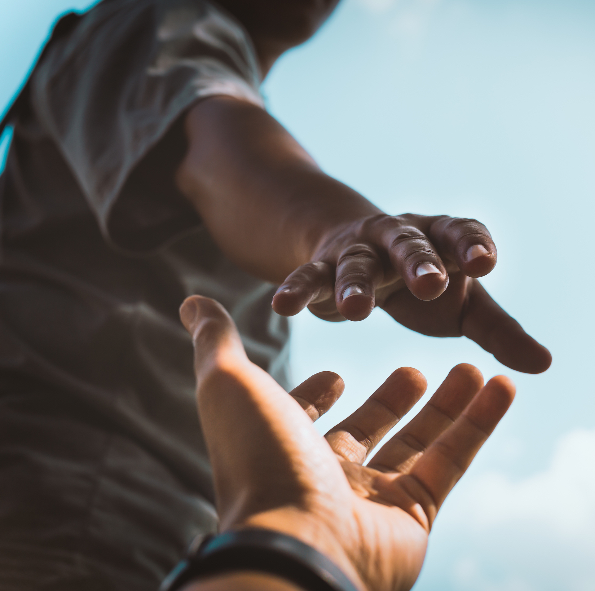 Help Concept hands reaching out to help each other in dark tone.